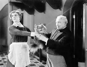 Seriousness: Housekeeper is pushing a puppy away