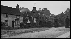 Roadway: Houses approaching a grand gateway