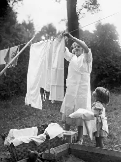 Housewife: Housewife hangs up laundry