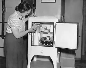 Refrigerator: Housewife with a modern refrigerator, 1936