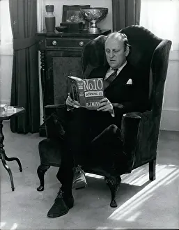 Texts: Humphrey Berkeley MP in his London flat, reading a book