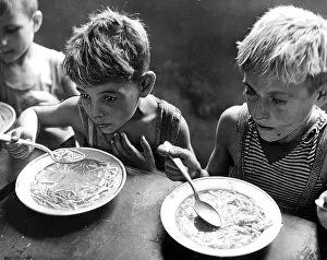 Governments: Two hungry kids eating their soup