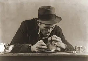 Depressions: Hungry man with his meal of bread and soup ?