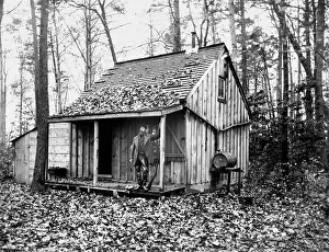 Centurys: Hunter Standing on Front Porch of Cabin in Woods