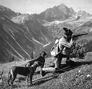 Huntsmen: Huntsman with two dogs, ca. 1935