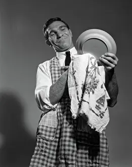 Wipe: Husband in apron drying dishes