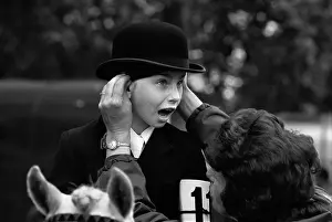 Ponys: Hyde Park young pony rider with hat being adjusted