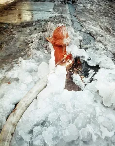 Hydrant: Ice Covered Fire Hydrant and Connected Hose During