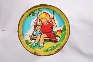 Stacking: Illustrated tin can - girl on a swing