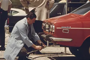 Emission: An inspector testing the exhaust of an automobile ?