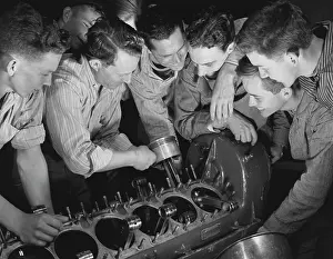 Instructor: Instructor showing a group of men how to assemble