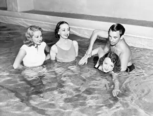 Blonds: Instructor teaching women how to swim