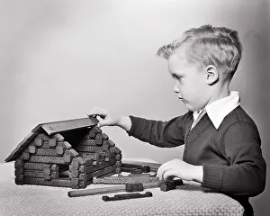 Solving: Intent Young Blond Boy Playing Building Model