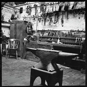 Foregroundthe: The interior of a workshop with a blacksmiths anvil
