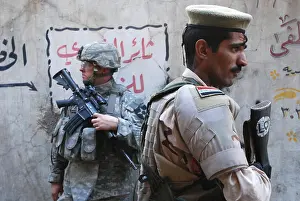 Crocker: US and Iraqi army soldiers stand guard a ?