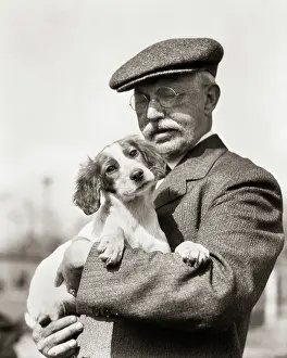 Upland: Irish Red and White Setter Puppy Held in Arms