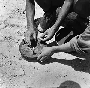 Disarming: Two Italian soldiers disarming a land mine in
