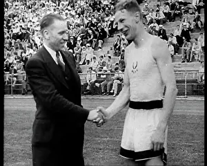 Someone: Jack Lovelock Shaking Hands With Someone as Crowds Watch
