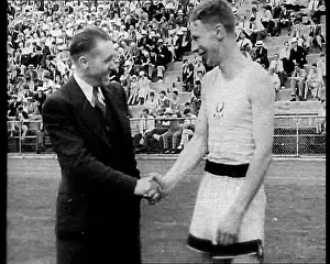 Someone: Jack Lovelock Shaking Hands With Someone as Crowds Watch