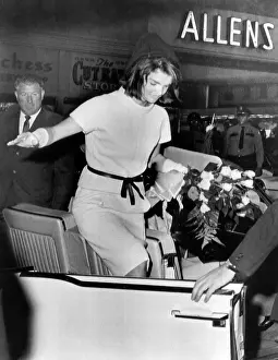 Exits: Jacqueline Kennedy balances gracefully as ?