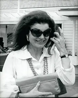 Clutch: Jacqueline Kennedy Onassis leaving a restaurant