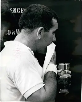 Staid: Jacques Grigry with glass of beer at Wimbledon