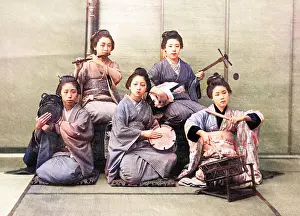 Japanese women playing on samisen, fuye, taiko, and tsuzumi