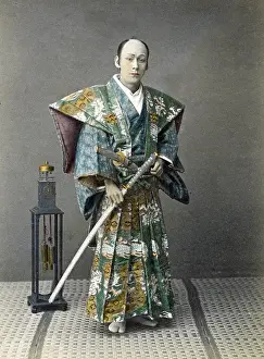 Samurai: Japense samurai (actor) with a clock, Japan, circa 1880s