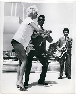 Attributes: Jayne Mansfield, actress, dances on arrival in Cannes