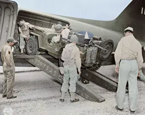 Jeep: A jeep is being loaded into a plane, circa 1942