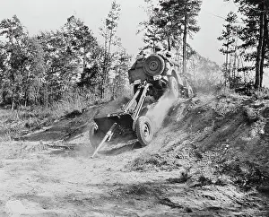 Towed: Jeep pulling a 37mm anti-tank gun across rough