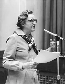 Mitford: Jessica Mitford speaking at a microphone
