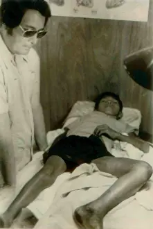 Communes: Jim Jones standing over a Guyanese boy with ?