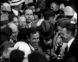 Mollison: Jim Mollison Walking Surrounded by a Large Crowd