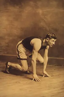 Decathlon: Jim Thorpe in runners starting position, c