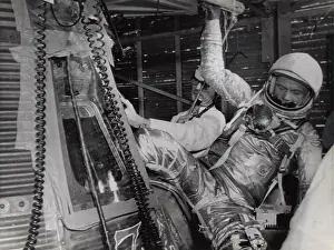 Climbs: John H Glenn climbs out of his Mercury space capsule