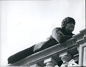 Parapet: John Lennon lying on a stone balustrade at stately home