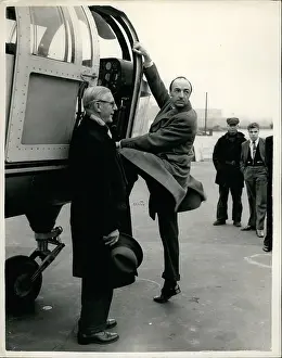 L.c.c: John Profumo MP getting into helicopter, London