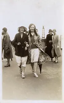 Confidently: Jolly young ladies stroll confidently along the seafront