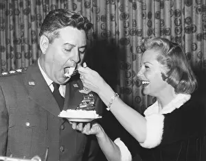 Lemay: June Allyson serving cake to General Curtis LeMay