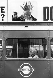 Camden: Juxtaposition of bus passenger and advertising punk