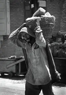 Manpower: Kashmir - ragged man carries bricks in basket