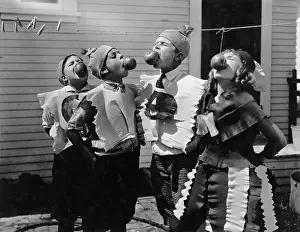 Wholesome: Kids biting apples on strings at Halloween
