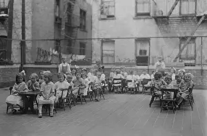 Tenements: Kindergarten children sit in chairs at long