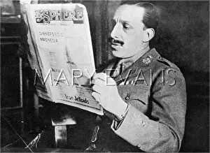 Narrowly: King Alfonso XIII of Spain reading The Sphere