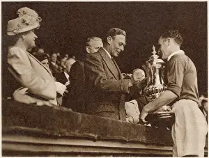 Presenting: King and Queen presenting the F.A. Cup to Johnny Carey