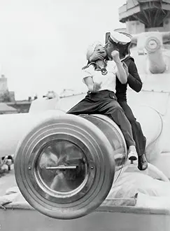Kissing sailor sitting on a muzzle