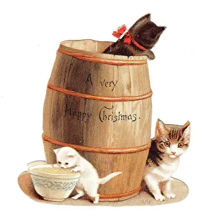 Lapping: Three kittens with barrel on a cutout Christmas card