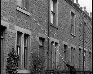 Poll: A Knocker Upper Uses A Long Poll To Rap Against