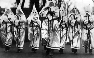 Frocks: Ku Klux Klan members at a march, 1925